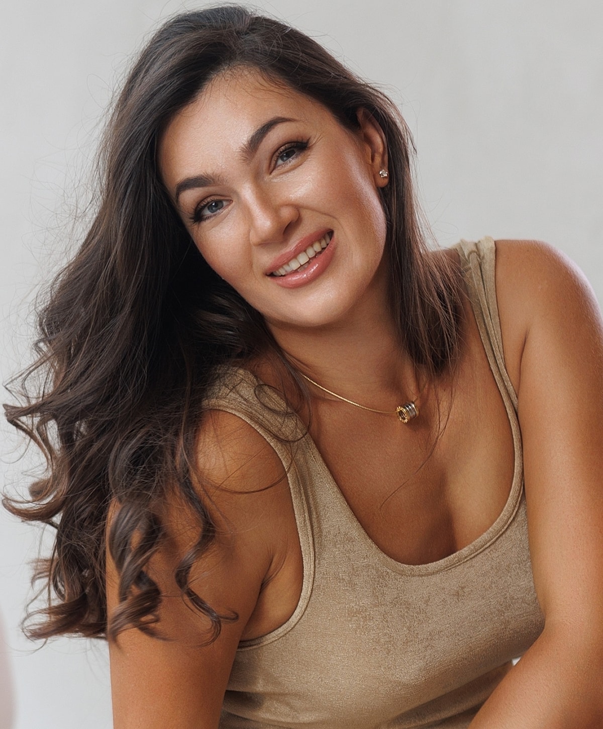 Close-up of model with glowing skin and freckles.