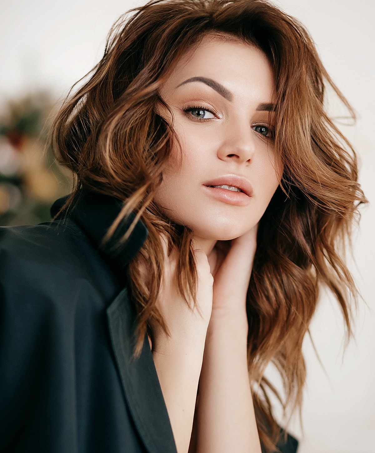 Woman with wavy hair in a black jacket.